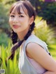 A young woman with long black hair smiling at the camera.